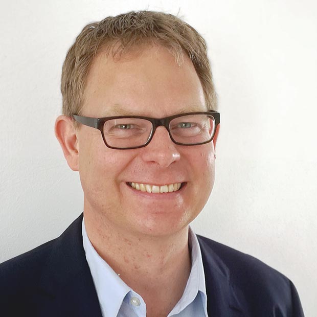 Dr. Sven Klimpe Mann mittleren Alters in Hemd und mit Brille schaut in die Kamera.